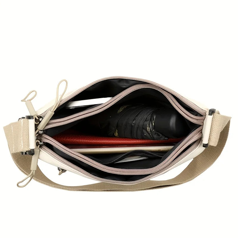 This large-capacity crossbody bag for women features a multi-zipper design and adjustable shoulder straps, making it suitable fo