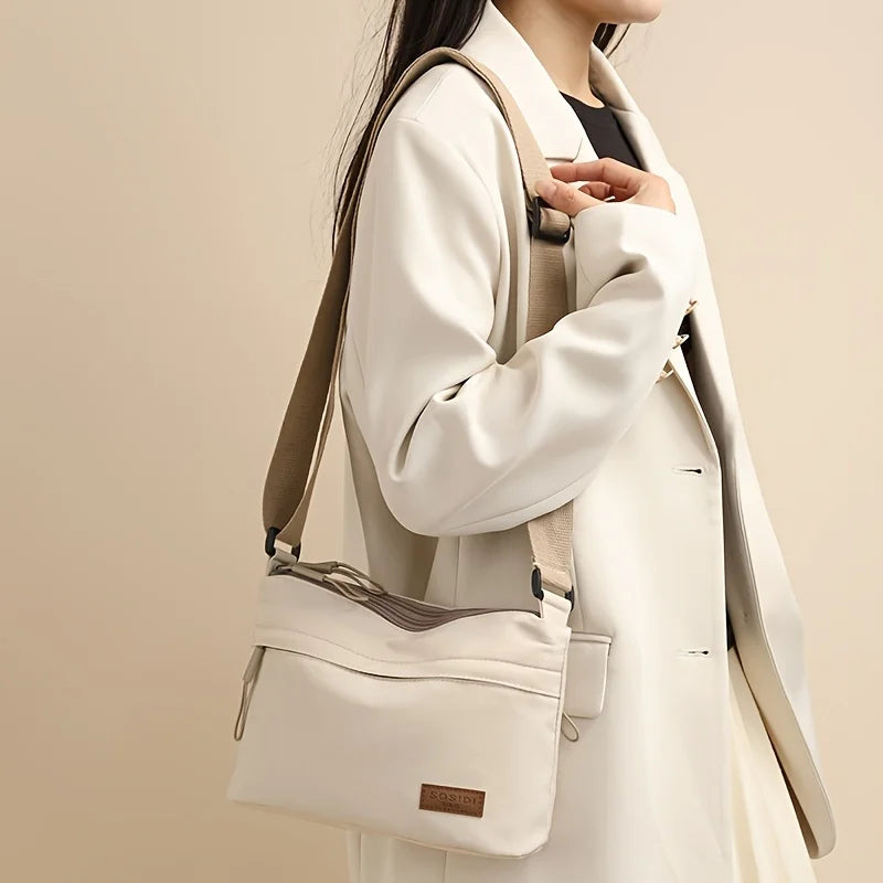 This large-capacity crossbody bag for women features a multi-zipper design and adjustable shoulder straps, making it suitable fo